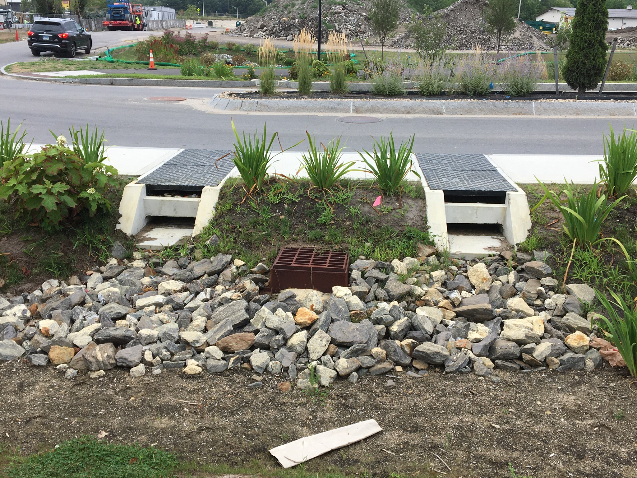 Two Rain Guardian Foxholes installed side-by-side spanning a concrete sidewalk